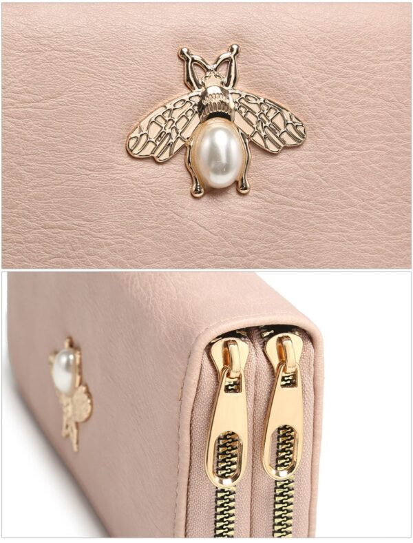 Alt Text: Close-up of gold bee and pearl embellishment on wallet