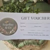 Close-up of SageBay & Co gift card showing logo and in-store redemption details
