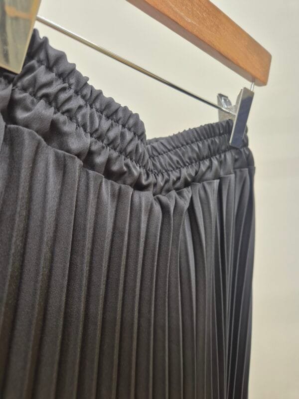 2026/01/1000388871-scaled.jpg Black Satin Pleated Midi Skirt