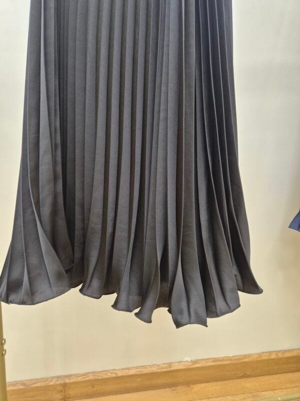 2026/01/1000388873-scaled.jpg Black Satin Pleated Midi Skirt