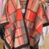 2026/09/JPEG_20260925_115136_8961473610849175778-scaled.jpg Orange/Chocolate Patterned Fringed Poncho